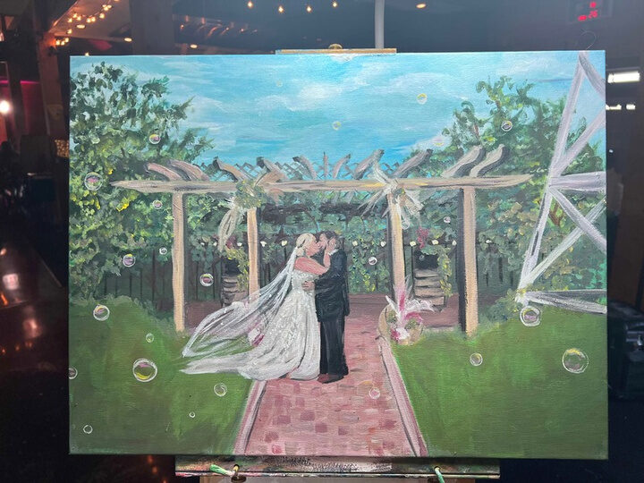Nicole’s canvas of the couple’s kiss under the pergola