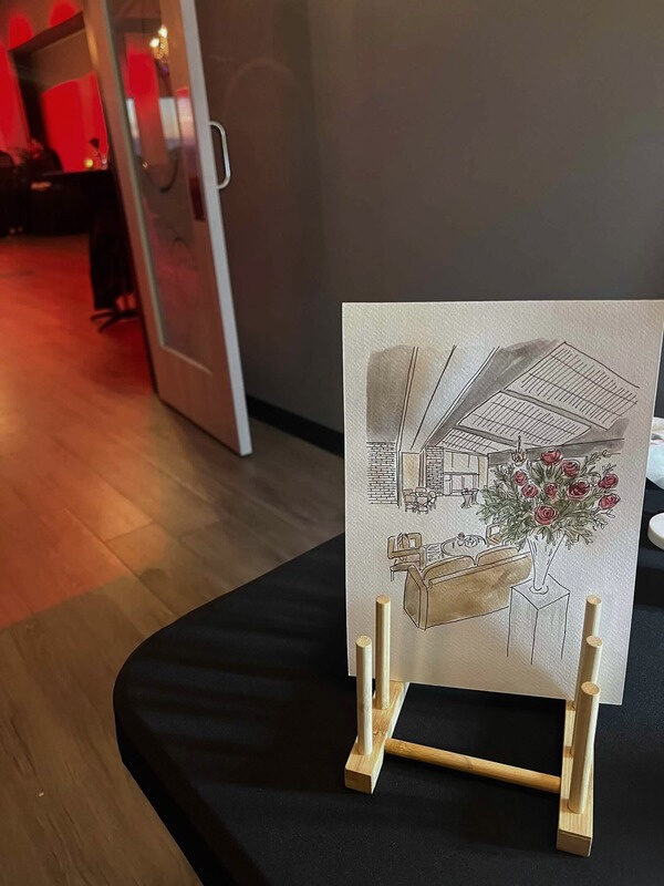 Nicole’s ink and watercolor painting of the rose arrangement, on a small easel
