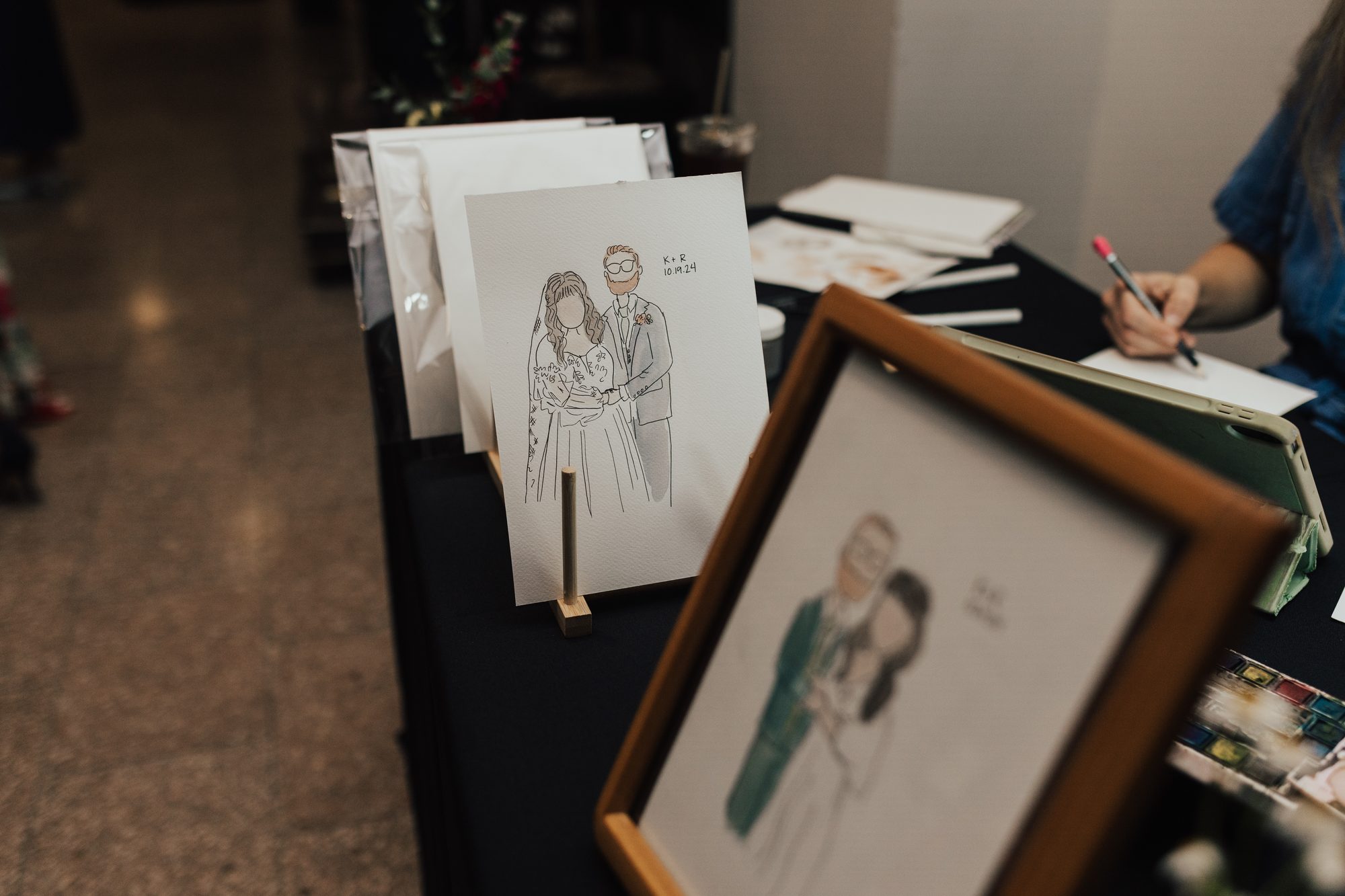 Finished mini portraits displayed on Nicole’s event table