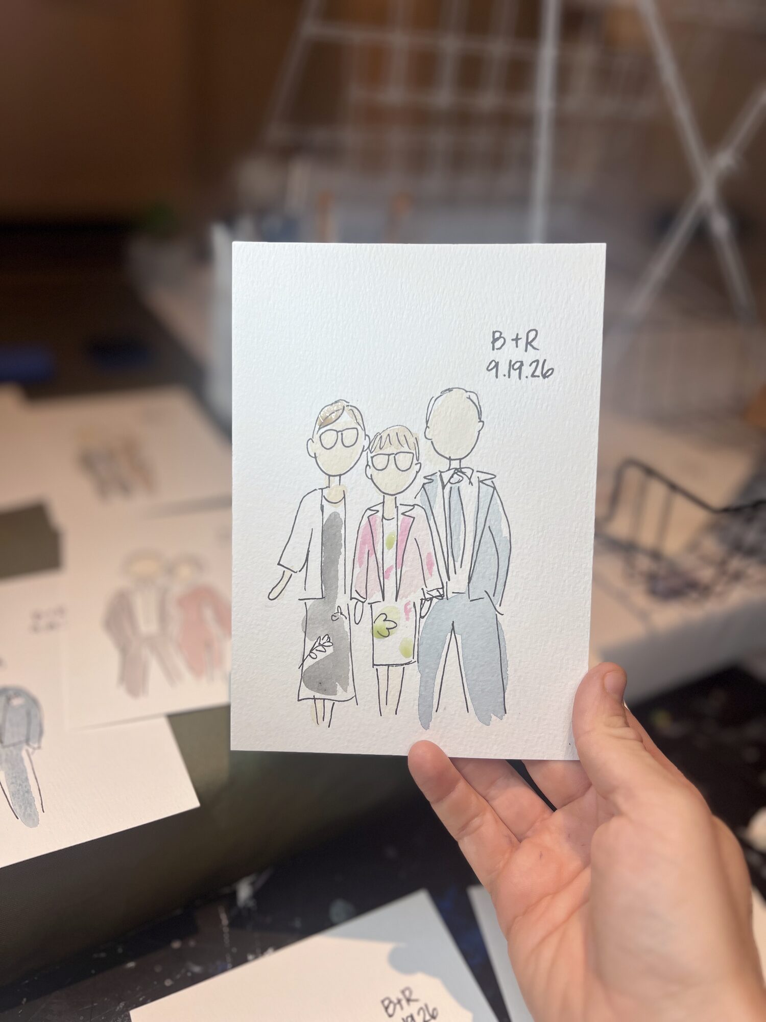 Mini portrait of three guests, held up beside the drying rack