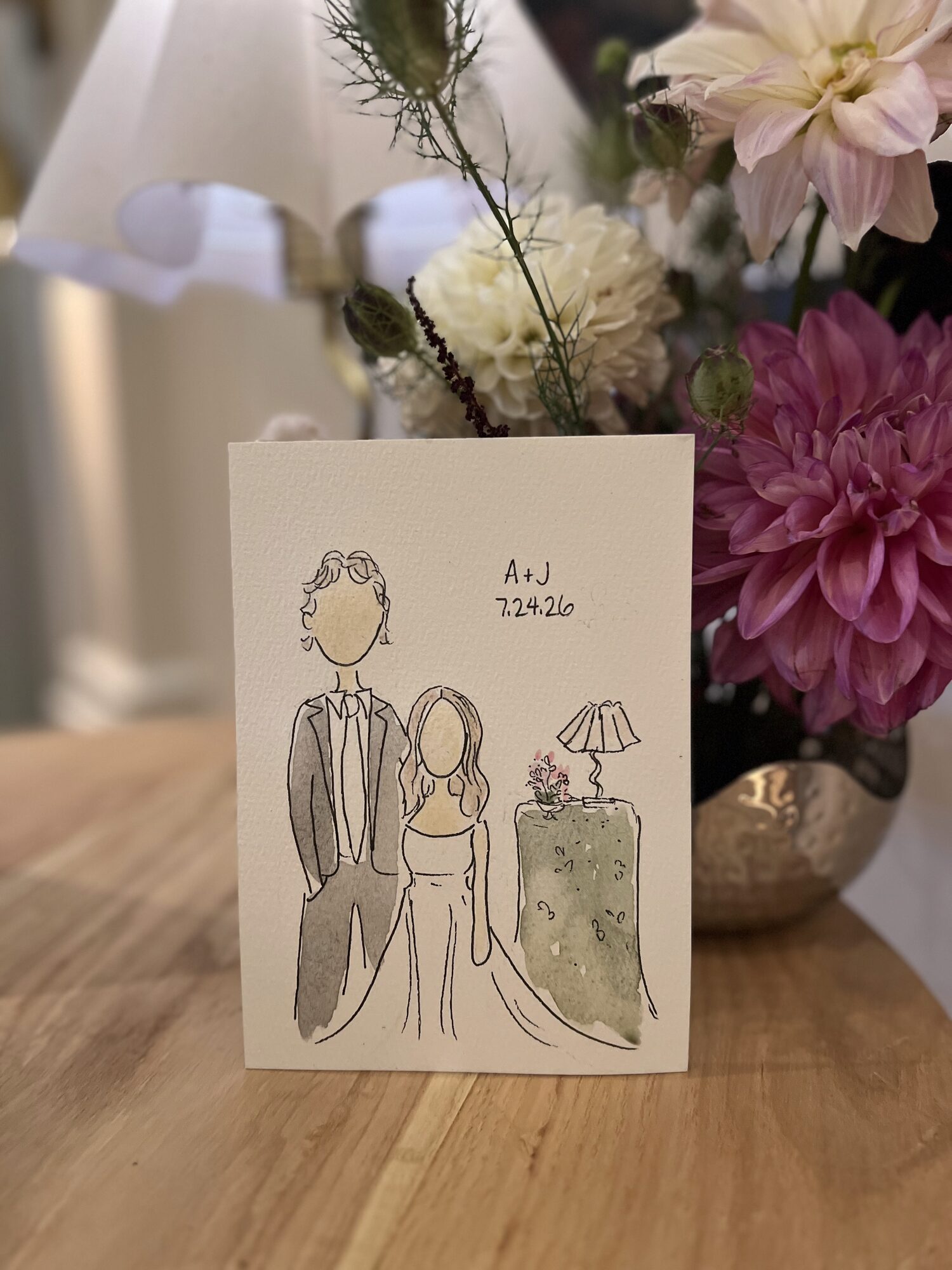 Mini portrait of a bride and groom with a painted table lamp, among dahlias