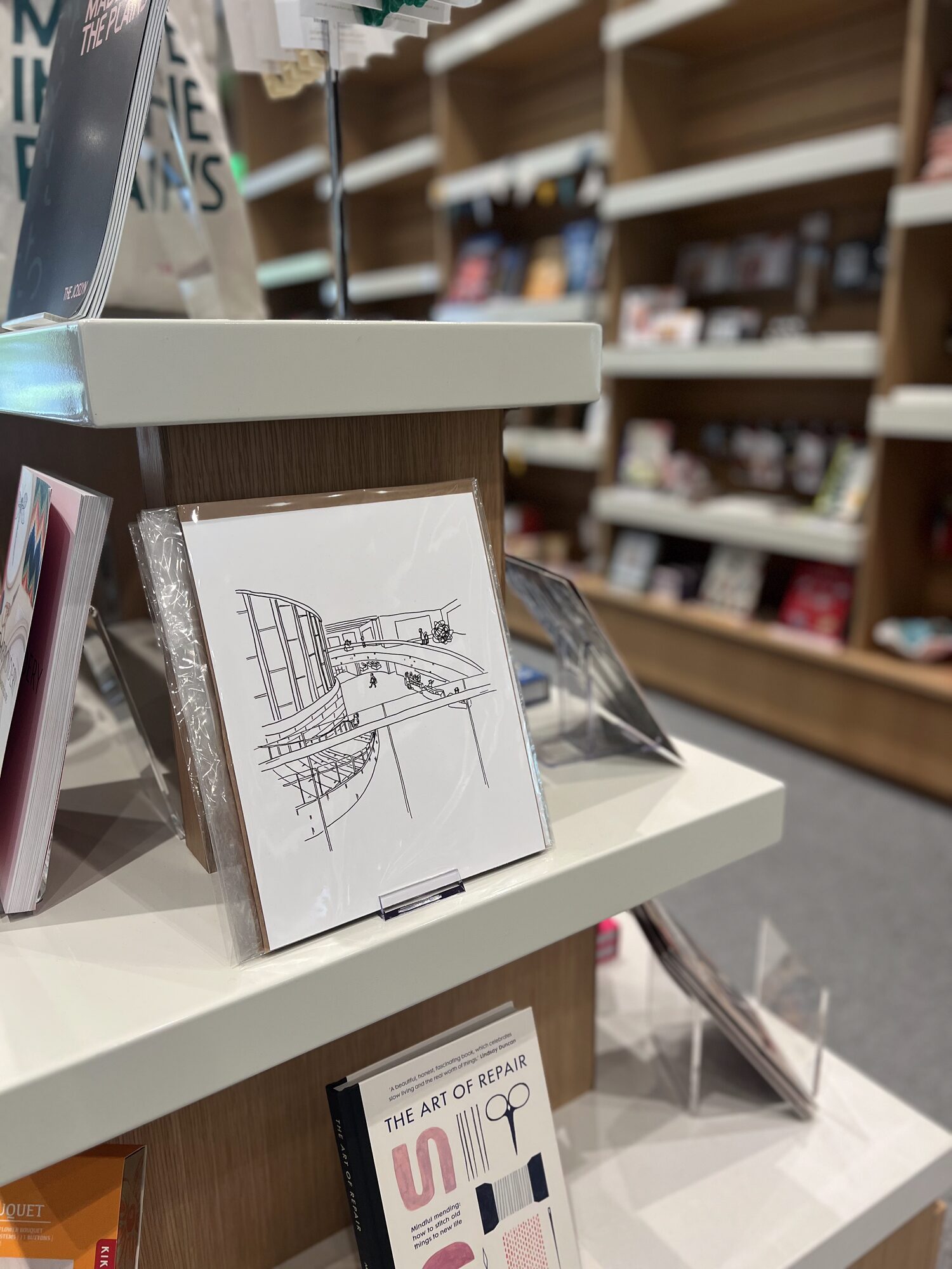 Nicole’s ink drawing of a city building on display at a bookstore